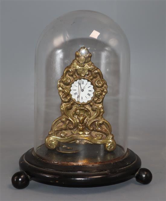 A 19th century brass timepiece under a glass dome clock 10cm high